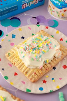 a birthday cake on a plate with sprinkles