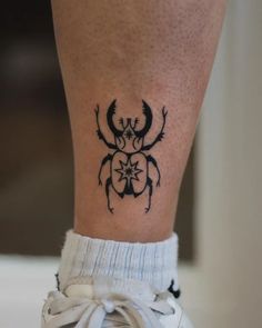 a tattoo on the leg of a person with an antelope in it's center