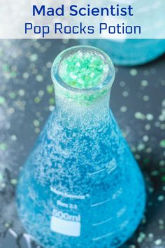 a blue and green liquid in a beakle with text overlay that reads mad scientist pop rocks potion