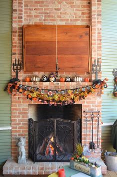 a fireplace decorated for halloween with pumpkins and decorations