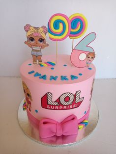 a pink birthday cake with lol surprise on top