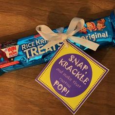 a wrapper and candy bar sitting on top of a wooden table next to a sign