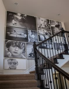 a staircase with many pictures on the wall