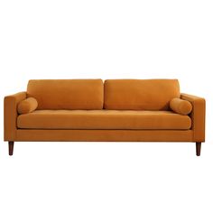 an orange couch sitting on top of a white floor