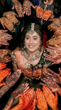 a group of people with their hands covered in hendikes and smiling at the camera