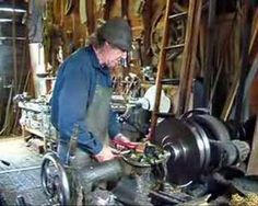 a man working on a machine in a shop