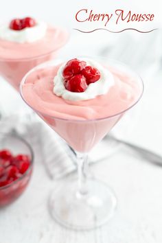 two small desserts with cherries on top