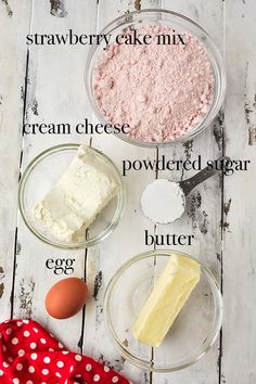 ingredients to make strawberry cheesecake laid out on a white wooden table with red polka dot napkin