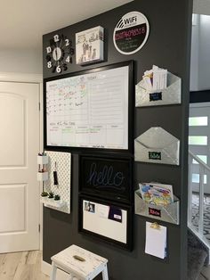 there is a wall with many magnets and pictures on it, as well as a white step stool