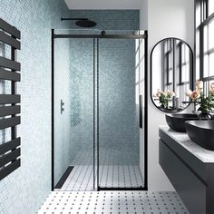 a bathroom with two sinks and a walk in shower