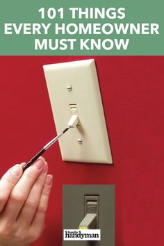 a person is using a screwdriver to fix a light switch