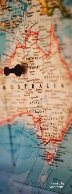 a close up view of australia on a world map with a small black object in the middle