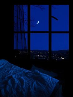 an open window at night with the moon in the sky