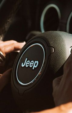 the steering wheel of a car with a jeep logo on it