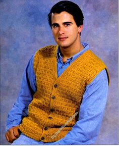 a man wearing a yellow vest and blue shirt