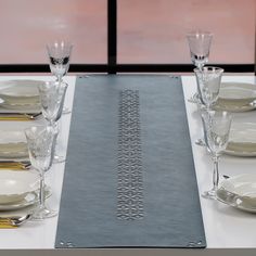 the table is set with silverware and place settings for four people to sit at