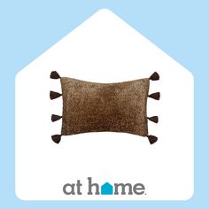 a brown pillow sitting on top of a blue and white house with the words at home above it