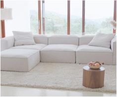 a living room with a large white sectional couch