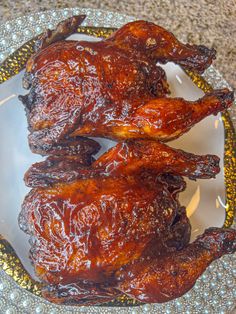 two pieces of chicken sitting on top of a plate