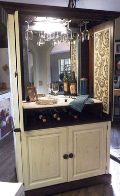 a large mirror on top of a wooden cabinet