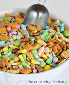 a bowl full of cereal with a spoon sticking out of the top in front of it