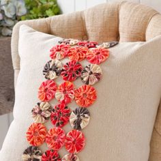 an embroidered pillow with flowers on it