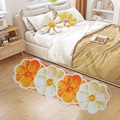 a bed room with a neatly made bed and flowers on the floor next to it