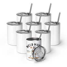 six white cans with straws in them