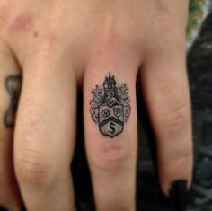 a person with a small tattoo on their finger