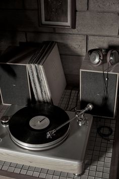 a record player sitting on top of a wooden table