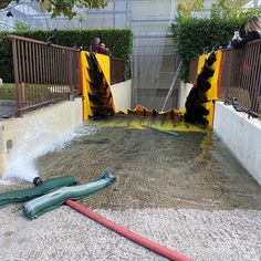 a fire hydrant that has been knocked over and is on the ground next to a hose