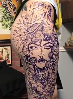 a woman's thigh with tattoos on it and an image of a woman in the middle