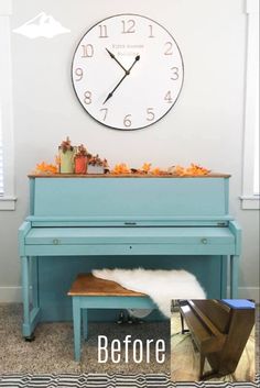 a blue piano sitting in front of a clock