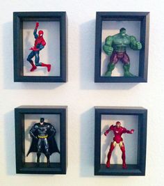 three framed photos of superhero action figures on the wall