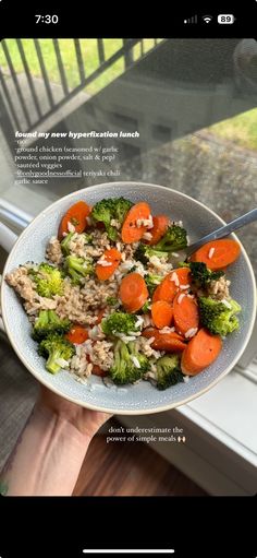 a person holding a plate with rice, carrots and broccoli on it