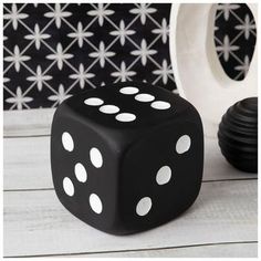 a black and white dice sitting on top of a table