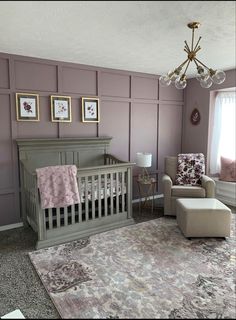 a baby's room with purple walls and furniture