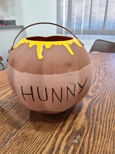 a clay pot with the word humpy painted on it sitting on a wooden table