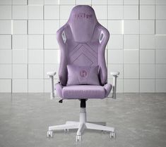 a purple office chair sitting on top of a white table next to a tiled wall