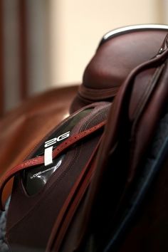 a brown leather bag sitting on top of a chair