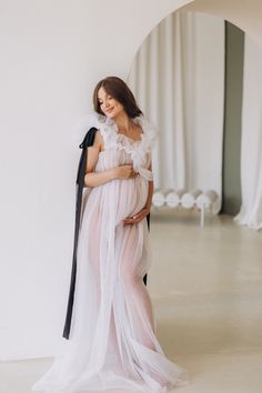 "💖 Whether you're looking for a chic maternity gown for your photo shoot or a stunning dress for a special event, this tulle maternity gown is the perfect choice. It is tailored to your custom measurements to ensure a perfect fit, making you feel comfortable and confident throughout the event.    💖 With its timeless elegance and understated sophistication, this renaissance dress is the perfect choice for any occasion. The dress is made from high-quality tulle fabric, giving it a light and airy Feminine Tulle Dress With Sheer Sleeves, Elegant Maternity Flowy Gown, Maternity Fitted Dress With Tulle Skirt, Elegant Summer Tulle Maternity Dress, Feminine Sheer Tulle Dress, Sheer Flowy Dress For Wedding Night, Elegant Flowy Maternity Dress, Sheer Tulle Floor-length Maxi Dress, Ethereal Floor-length Tulle Dresses