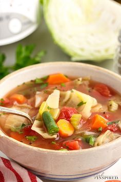 a bowl of vegetable soup with a spoon in it