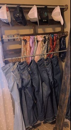 several pairs of jeans hanging on a clothes rack