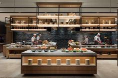 the chefs are preparing food in the large kitchen at the restaurant's counter top