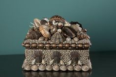 an ornate box with shells and seashells on it