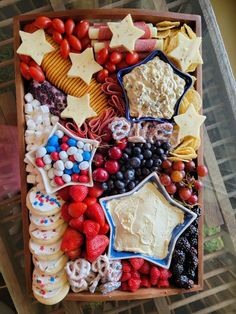 a wooden box filled with lots of different types of cookies and desserts on top of each other