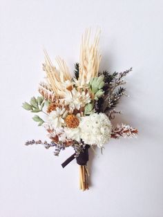 a bouquet of flowers and grasses on a white background