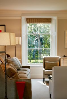 a living room filled with furniture next to a window