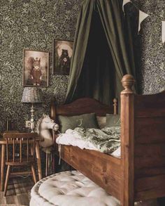 an old fashioned bedroom with green wallpaper and wooden bed frame in the corner, along with pictures on the wall