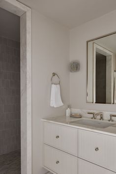 a bathroom with two sinks and a large mirror